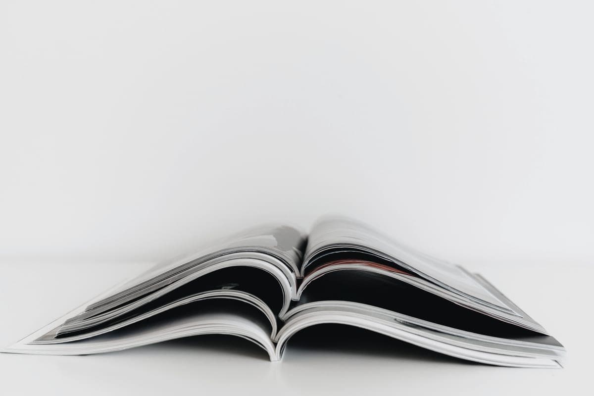 An open magazine on a white table, showing full-color print output