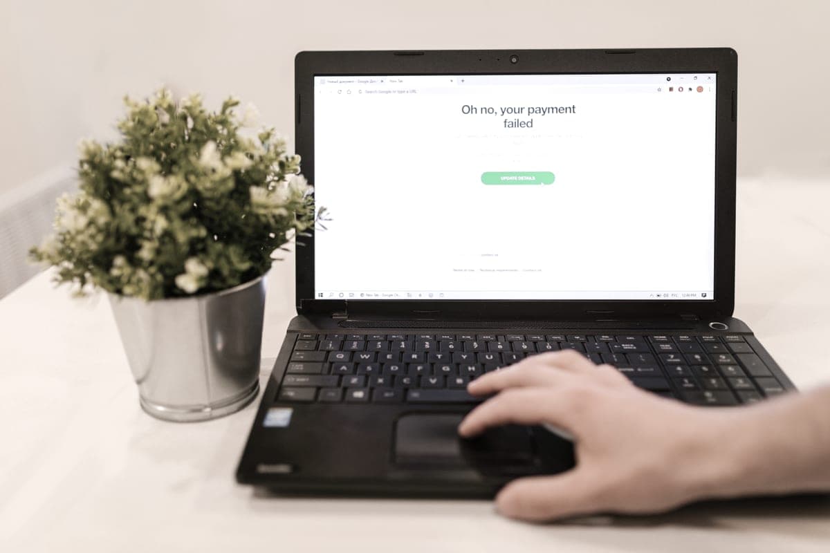 A person using a laptop showing an online account screen