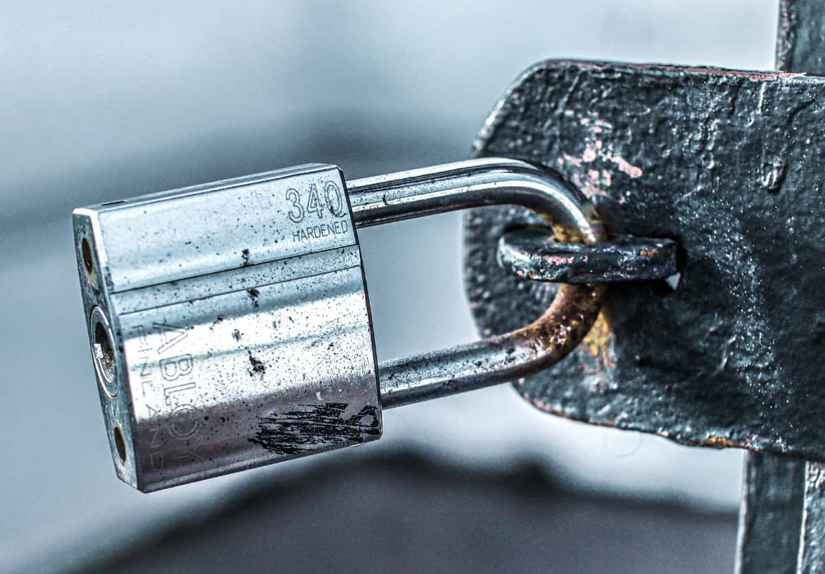 A close view of a padlock on a metal gate