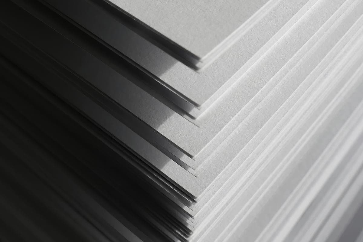 The corner of a neat stack of plain white paper